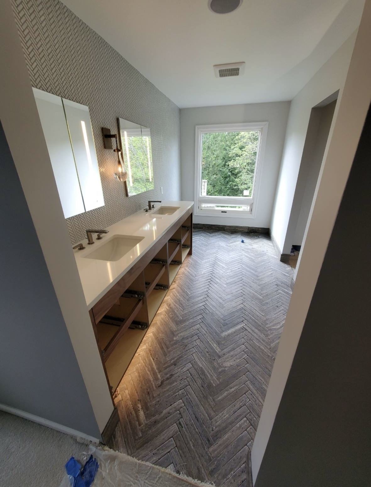 Bathroom remodel — double vanity with herringbone floor